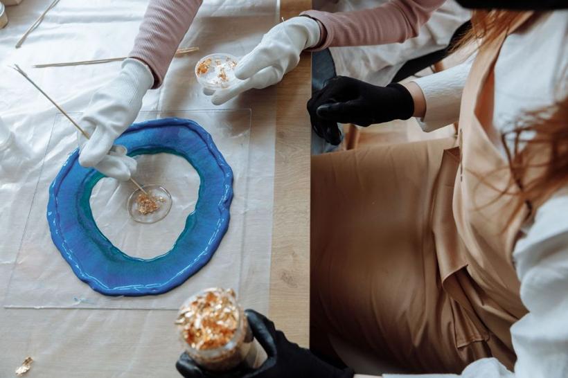Gold flakes being placed into wet resin